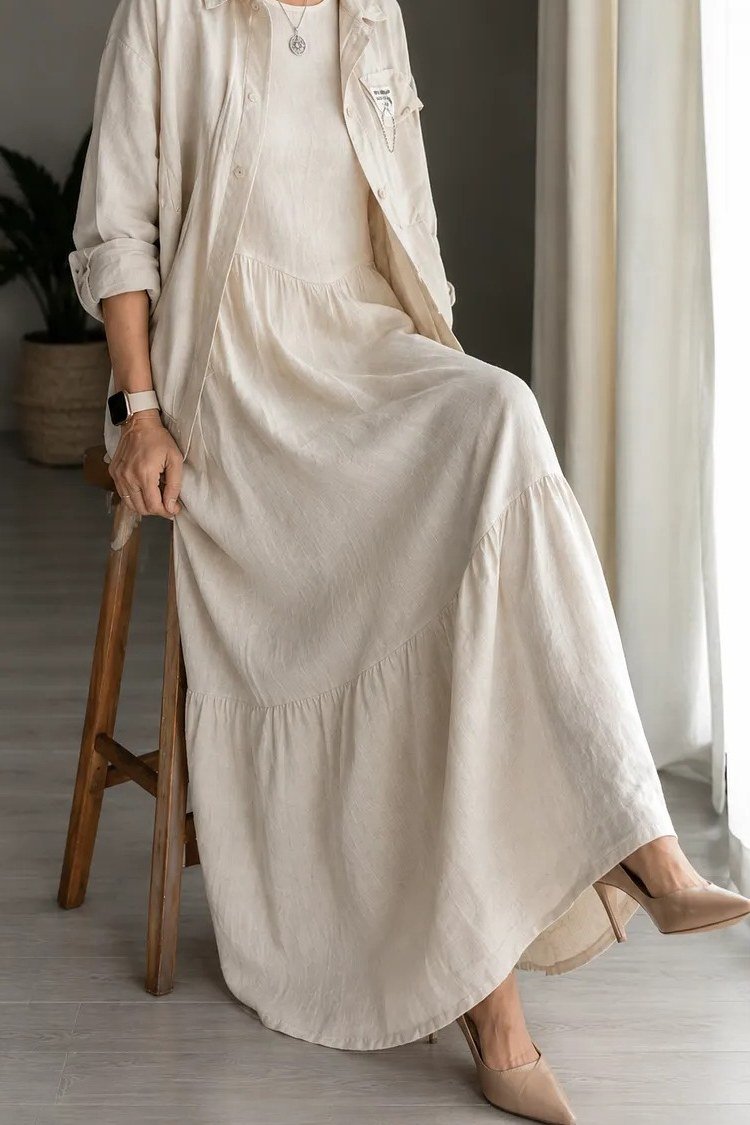 Cream tiered maxi dress with white shirt, seated for women over 60