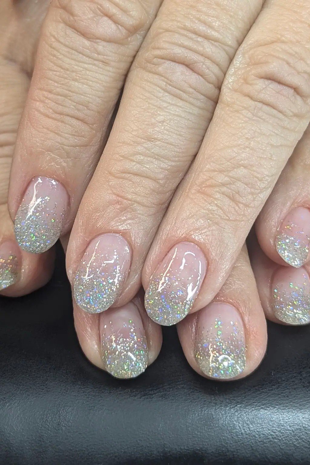 Nail art design for women over 60: mint glitter ombre on older hands