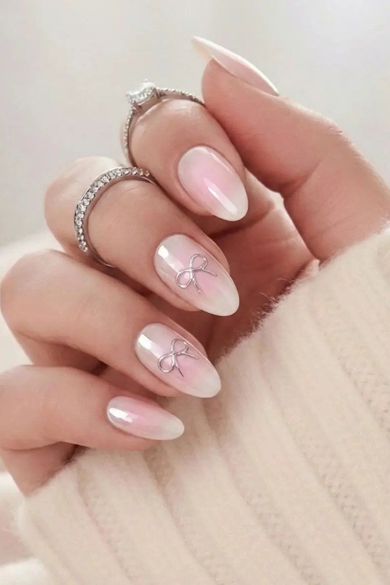 pink baby boomer fade with bow nail art on almond nails