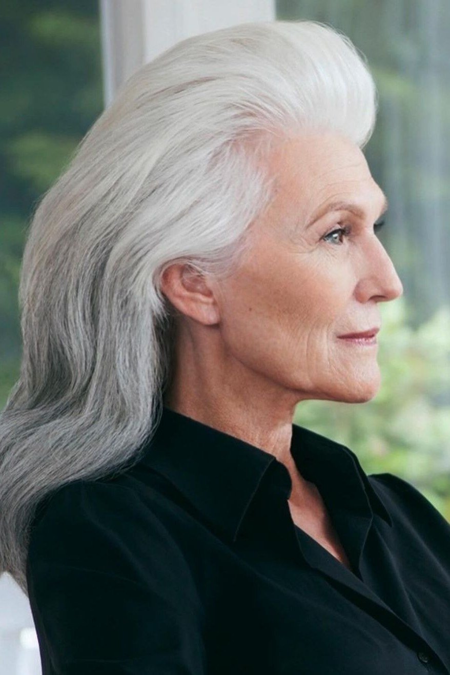Long silver-white straight layered hair with center part for women over 50