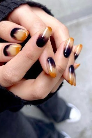 Black Amber Almond Ombre - Inky black at the cuticle melts into glowing amber at the tips of these almond nails.