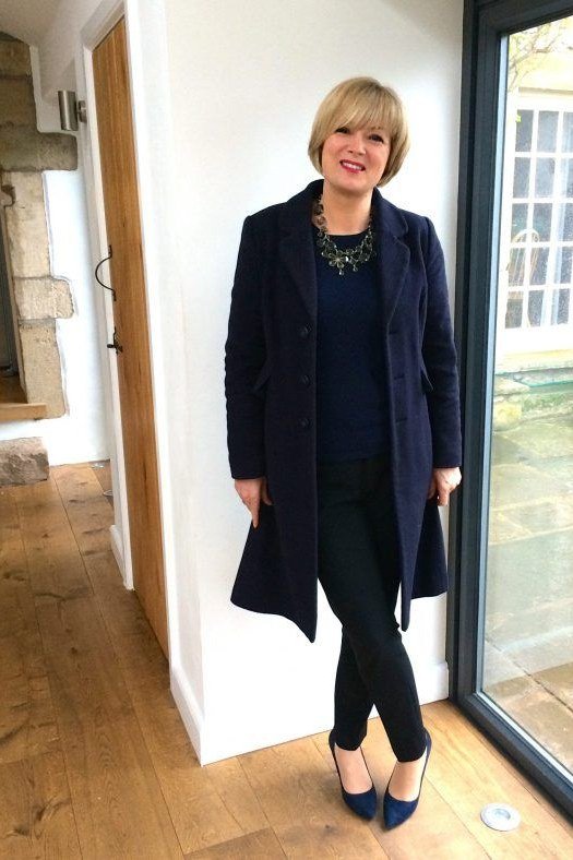 Work outfit for women over 40: long navy coat with black trousers