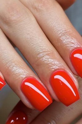 Coral red glossy nail polish