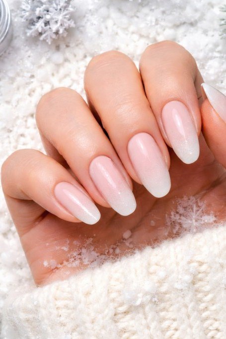 pink nude flatlay with polish bottles