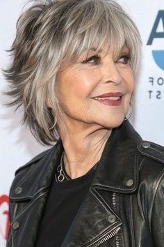 Silver shaggy bob with bangs, front view, smiling, classic hairstyle for women over 70