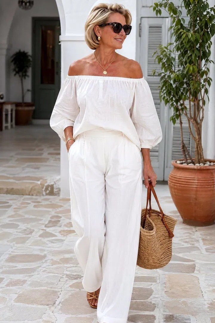 all-white off-shoulder top with white wide-leg trousers for women over 50
