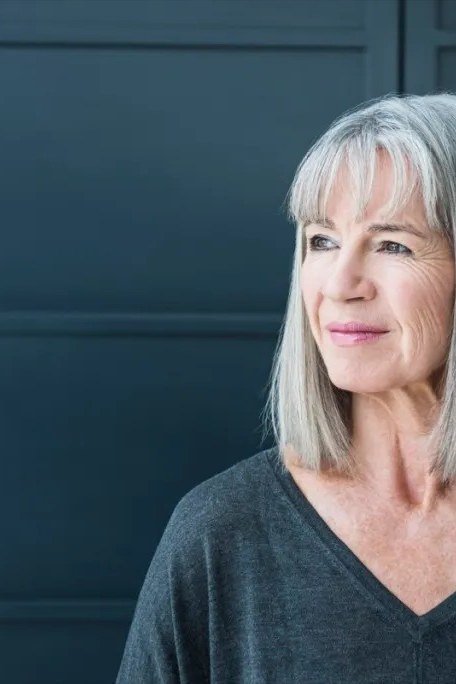 Silver straight shoulder-length cut with bangs, timeless hairstyle for women over 70