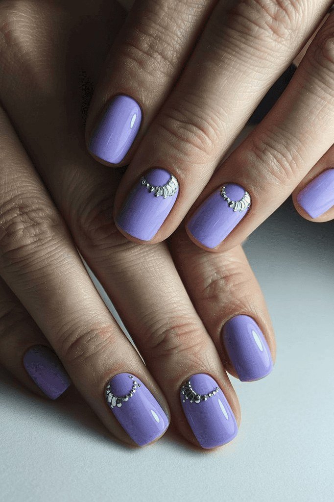 Periwinkle purple nails with rhinestone smile line accents