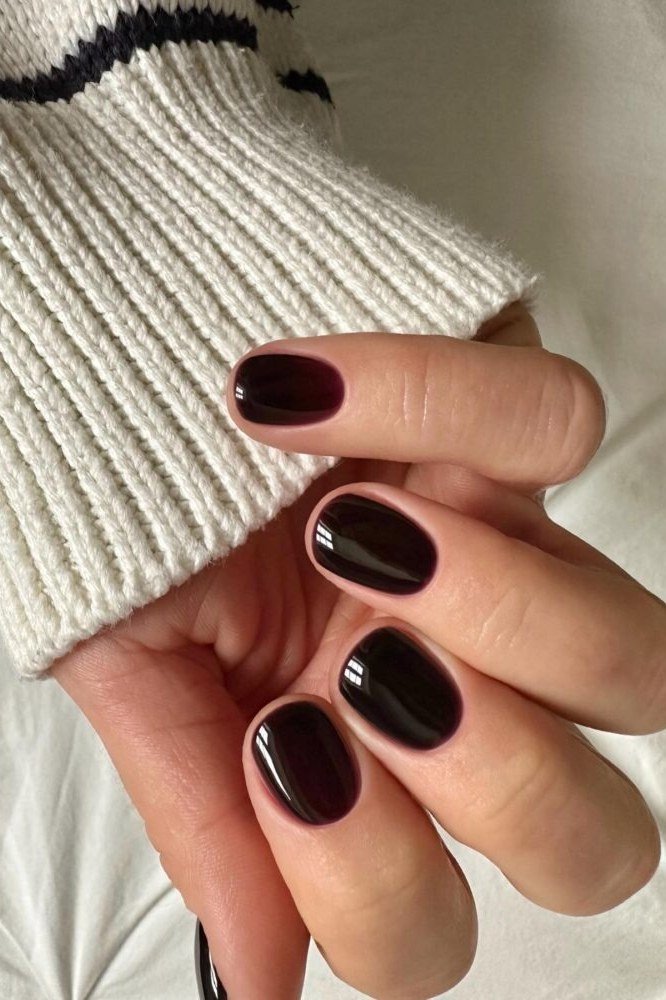 Burgundy Sweater Pose - short nail design for women over 60 that makes nails look longer