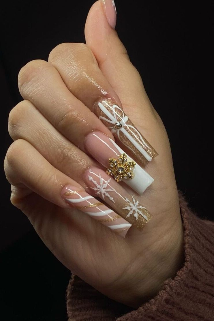 Nude nails with white bow and gold snowflake art - classy Christmas nail idea for women over 70
