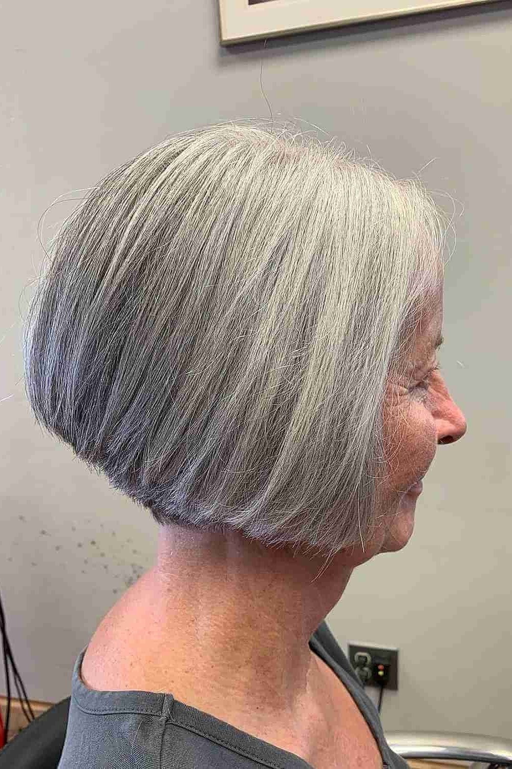 Salon-sleek silver bob haircut on an older woman, side profile, medium hairstyle for women over 60