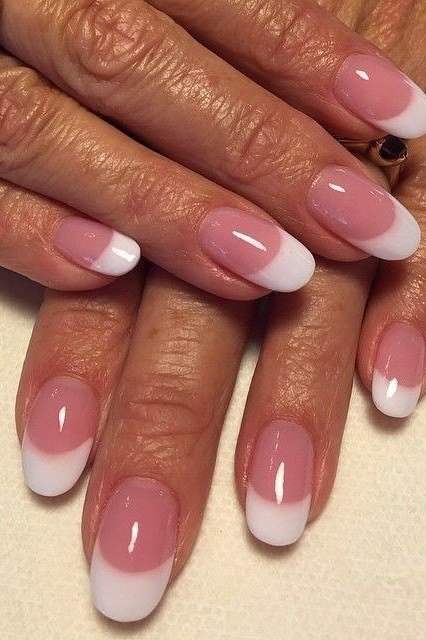 Pink ombre French manicure close up on mature hands