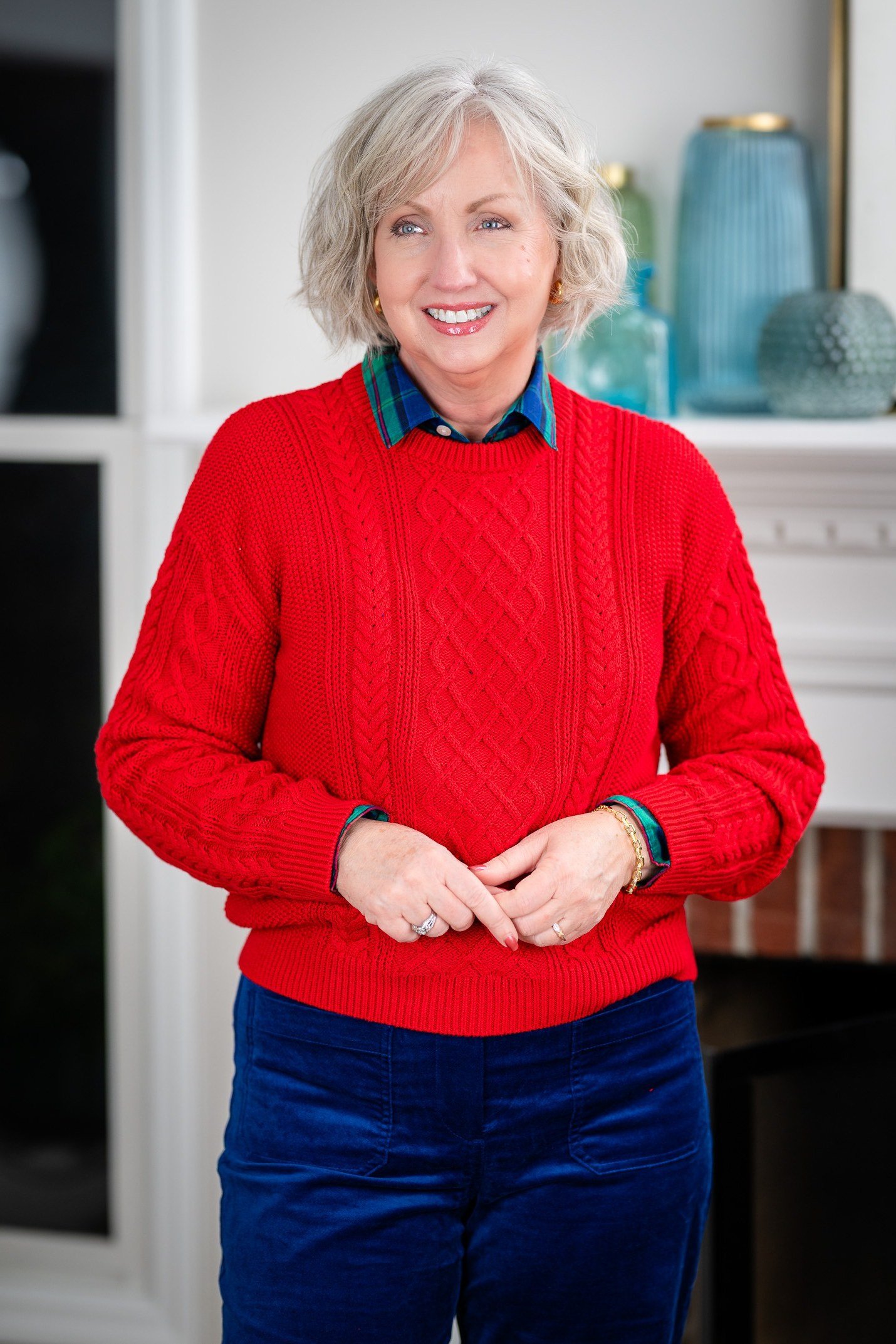 Cherry-red cable-knit sweater with royal-blue velvet trousers, cozy sweater outfit idea for women over 70