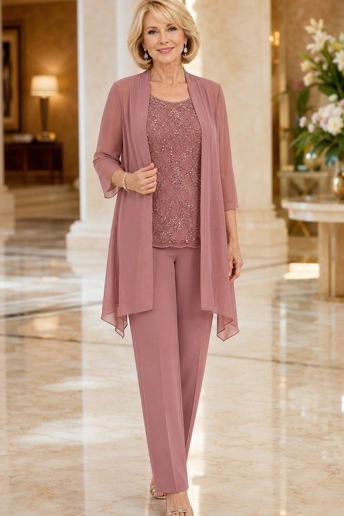 Older woman wearing a dusty rose cardigan and trouser set with lace top
