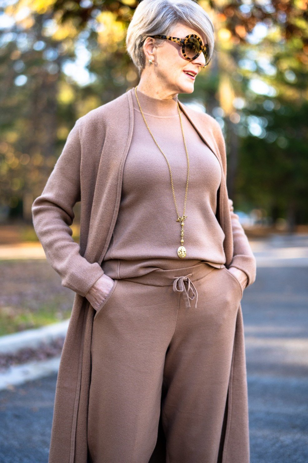 Matching mauve knit cardigan set with long necklace, woman over 50