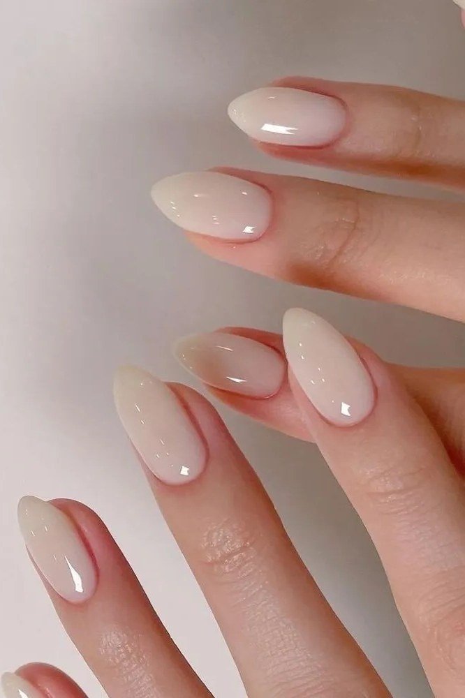 Milky pink almond glossy, elegant fall nail design for women over 40