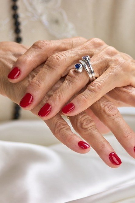 Classic red short nails on older hands, best manicure idea for women over 60