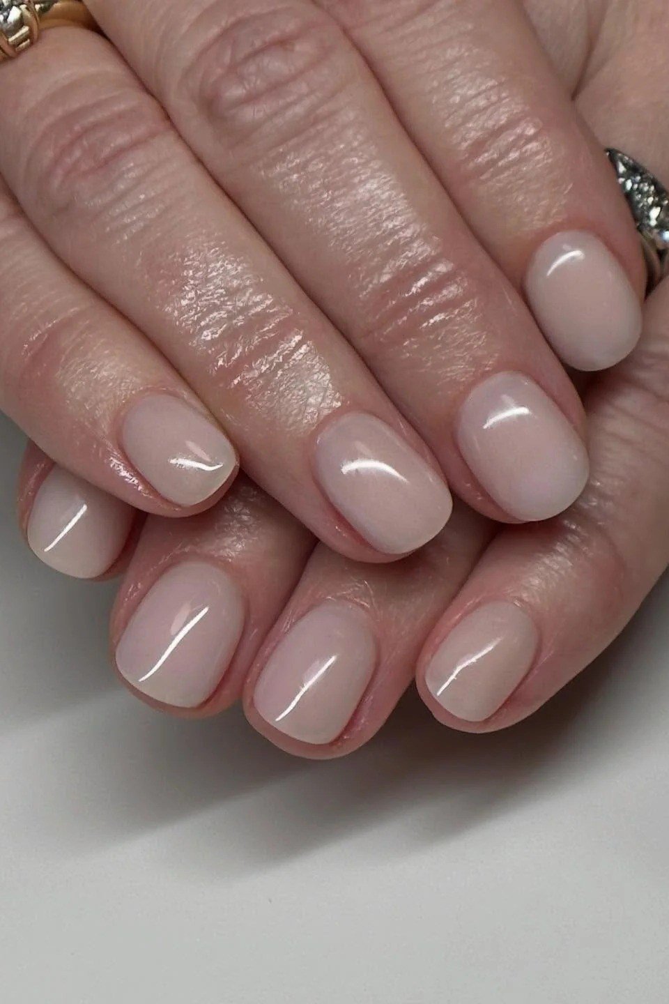 Glossy nude mature hands nails for women over 50