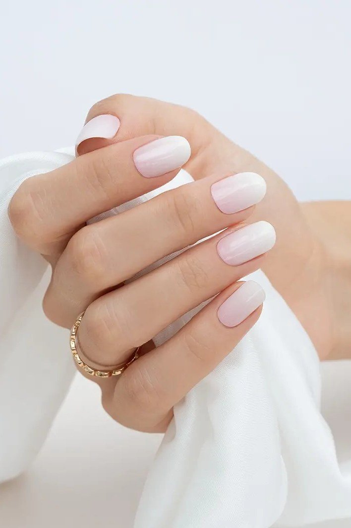 pink white baby boomer fade on short almond nails
