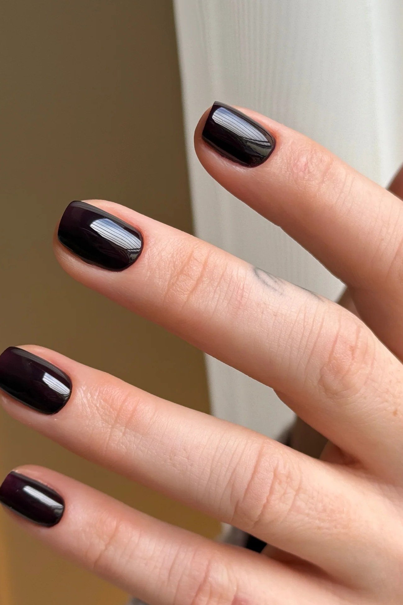 Dark Plum Almond - short nail design for women over 60 that makes nails look longer