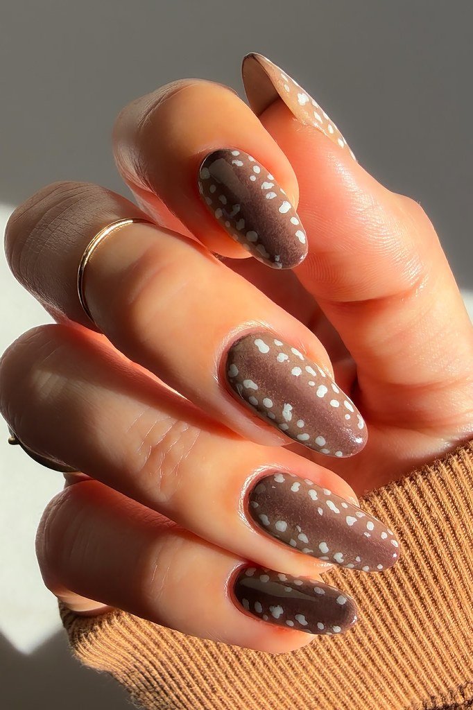 Mocha almond nails with white fawn spots and gold ring fall nails