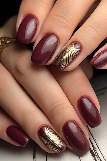 burgundy with gold shell accent nails - winter nail trend for older women