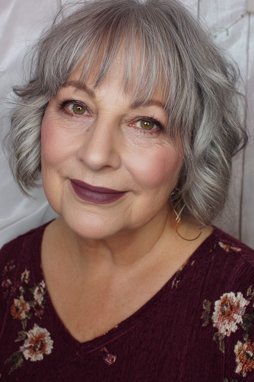 Textured grey french bob with bangs and floral top