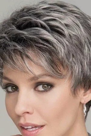 Grey feathered pixie, full bangs, close three-quarter view for women over 60