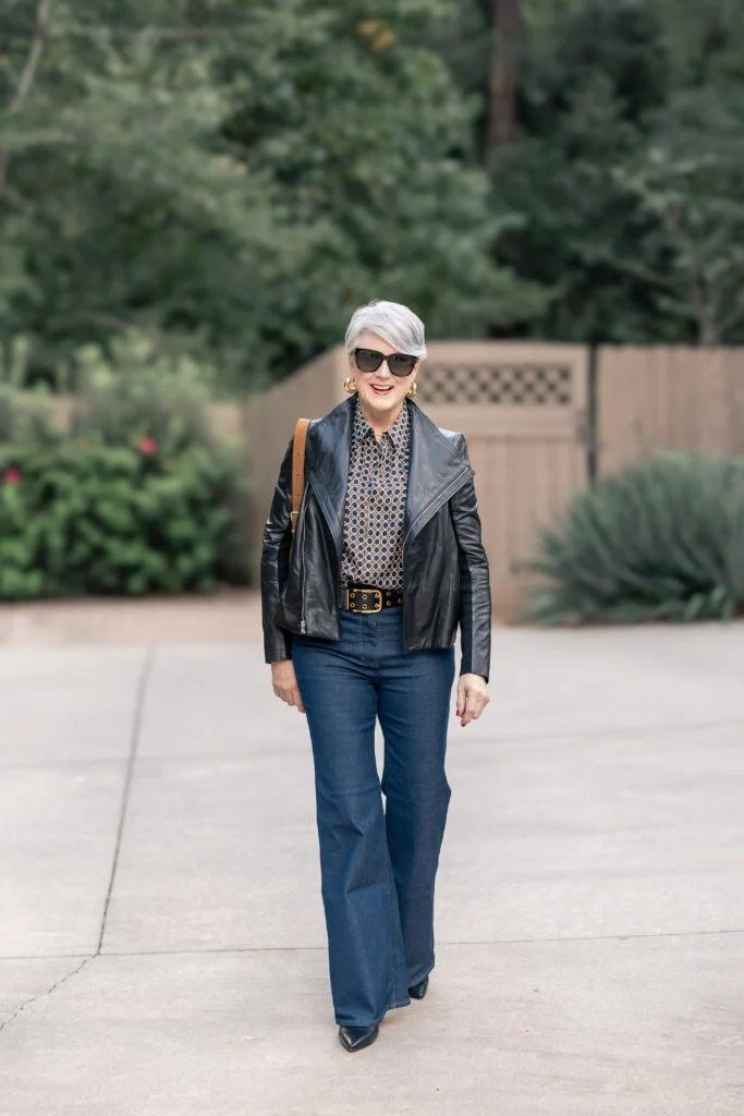Black leather jacket with blue jeans fall outfit idea for women over 60