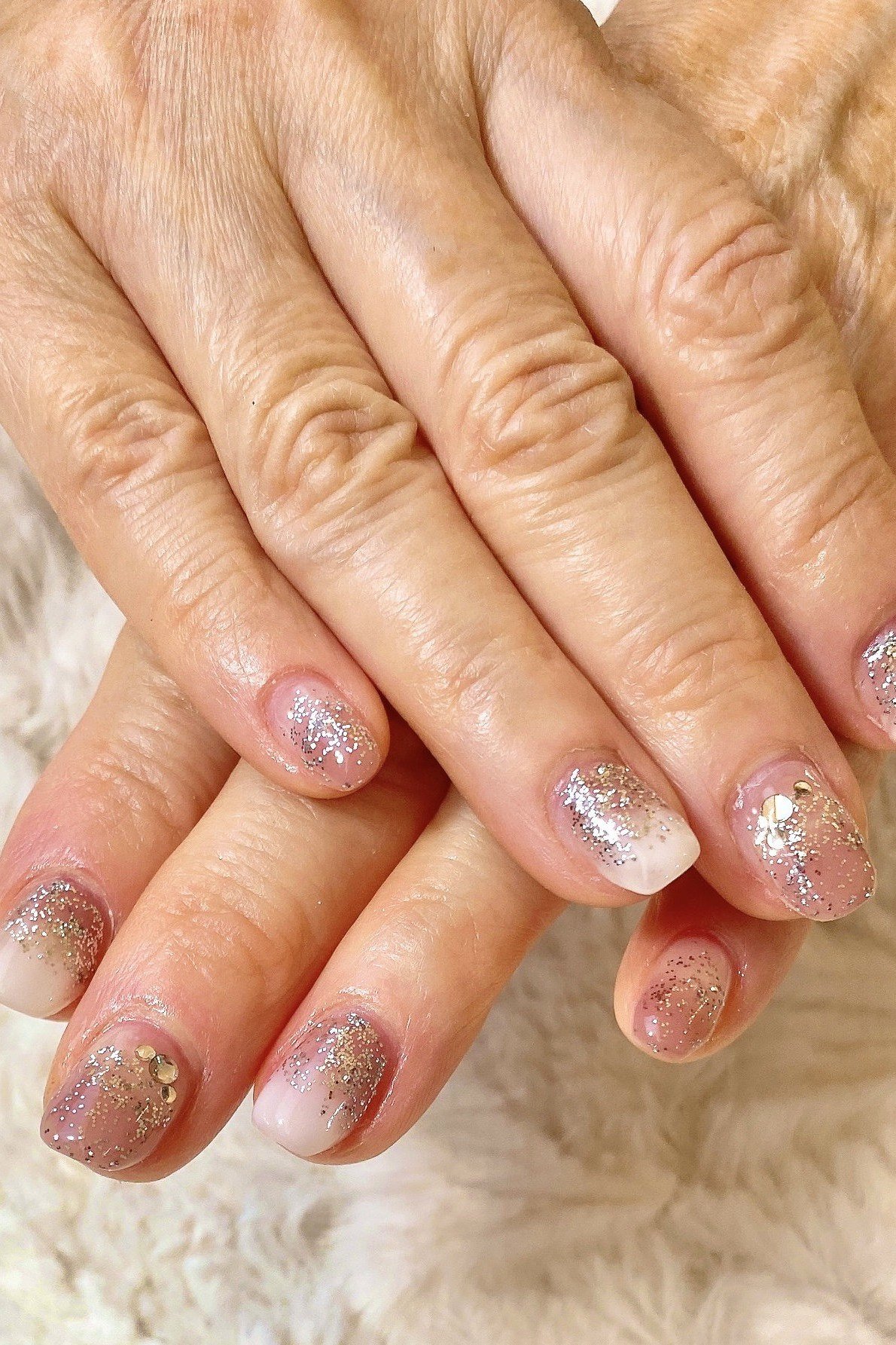 Silver glitter ombre on mature hands, short nails, ombre nail design for women over 60