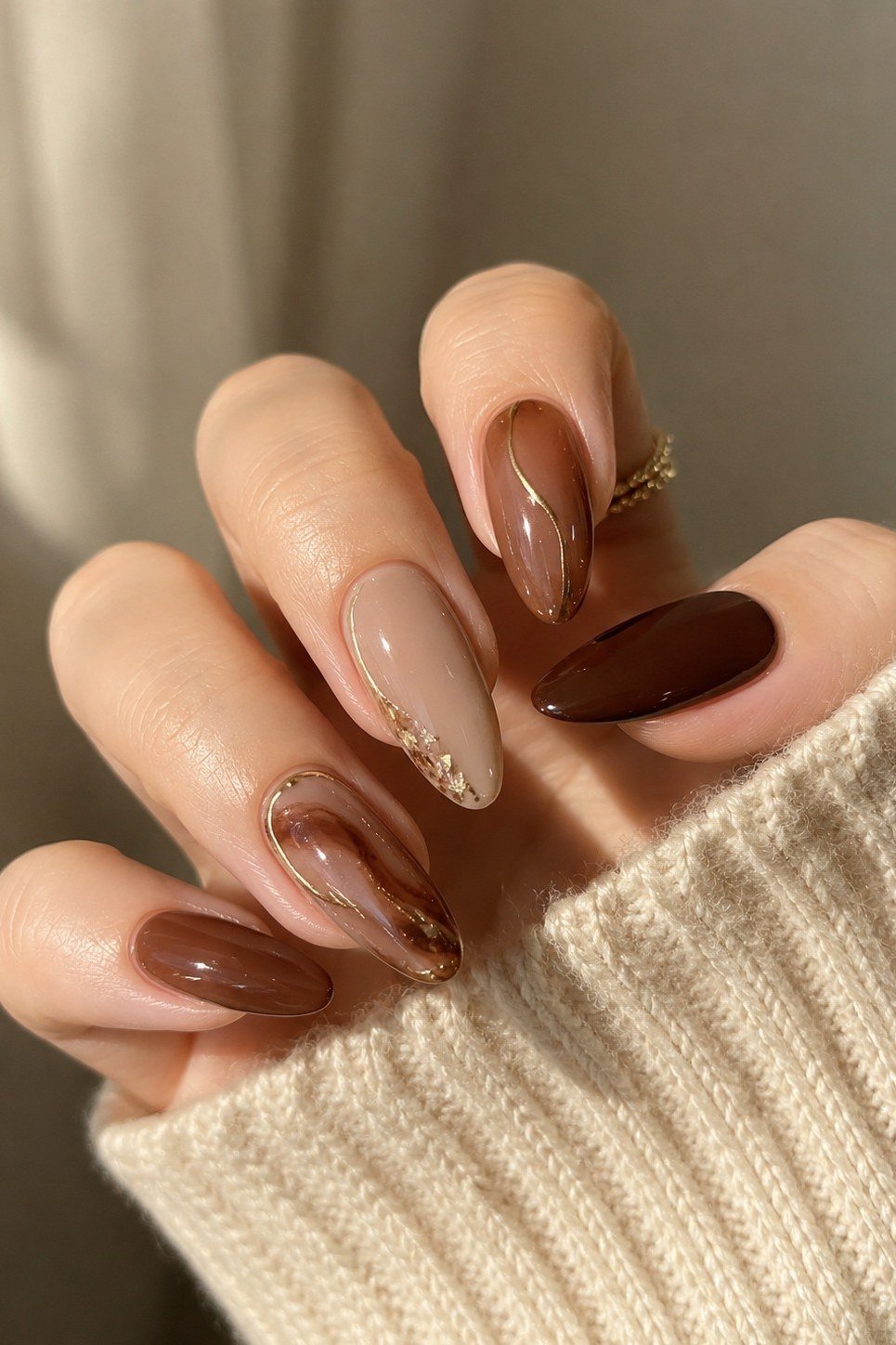 Brown ombre almond with gold shimmer, elegant fall nail design for women over 40