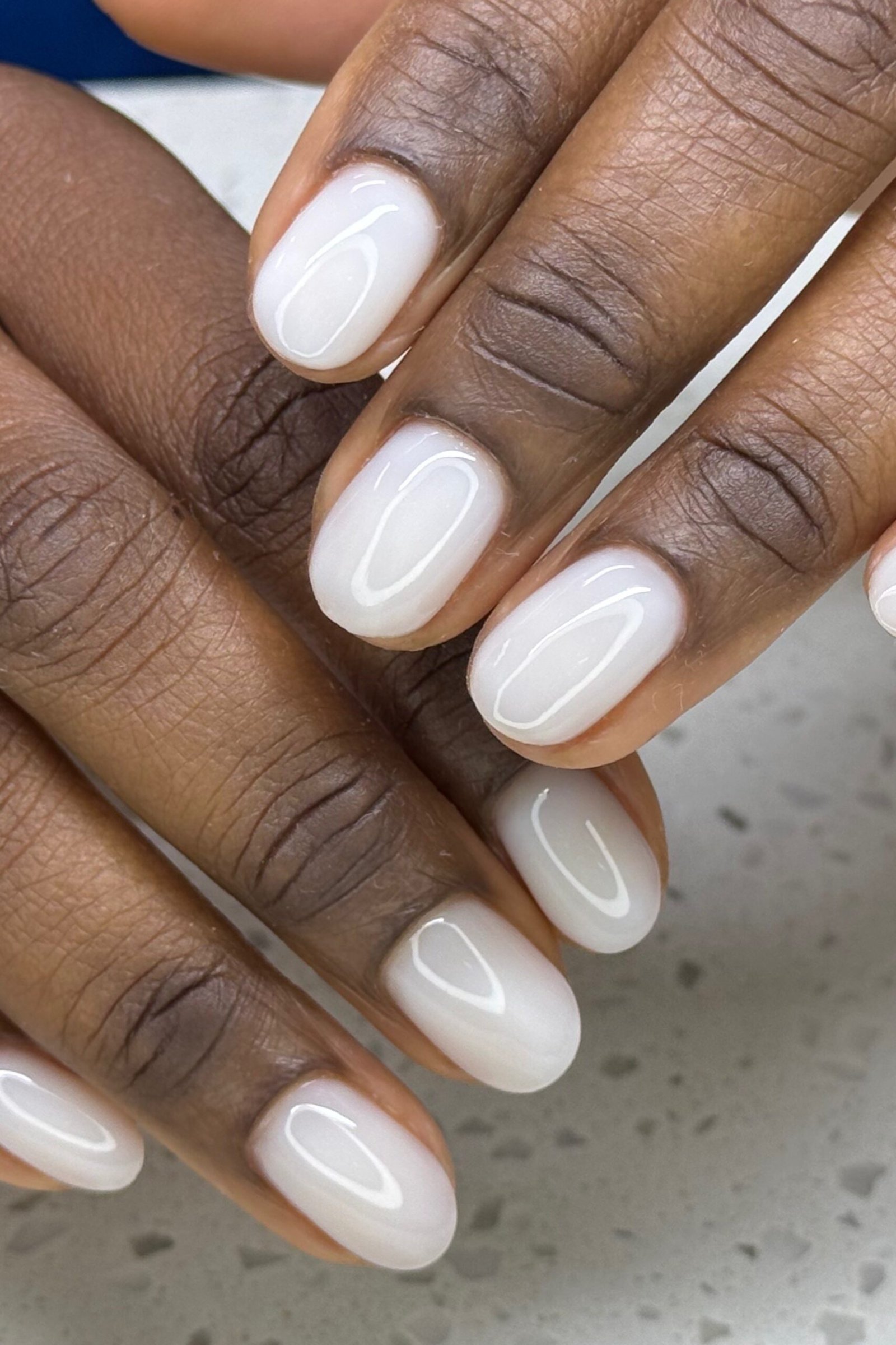 Short milky white square nails on dark skin