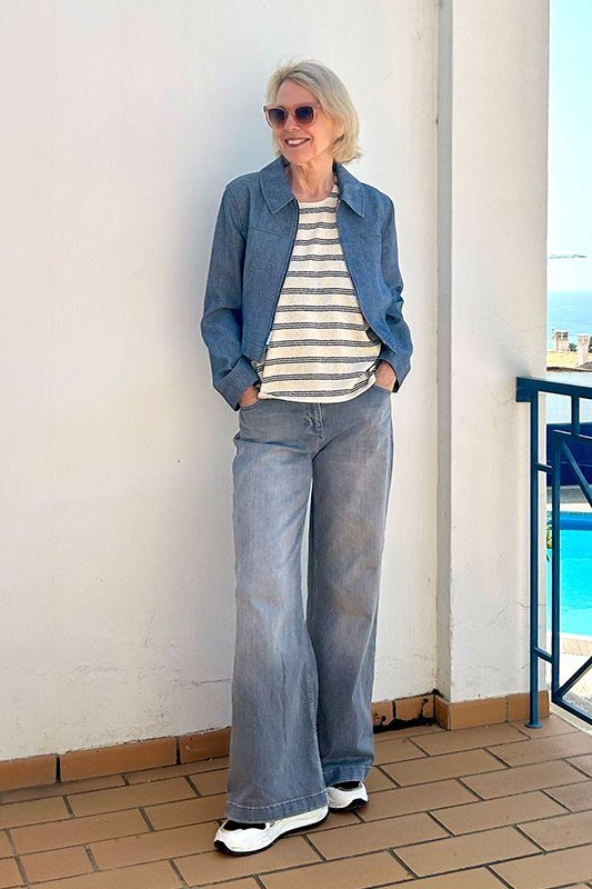 Woman over 50 wearing denim jacket with striped tee and wide-leg jeans, everyday casual outfit idea