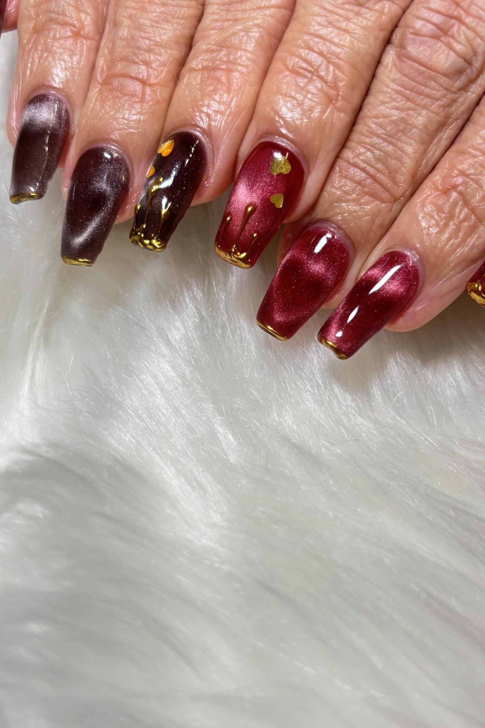 Black Cherry Cat Eye Nails - Near black cherry with deep red magnetic shimmer glows in this close up look.