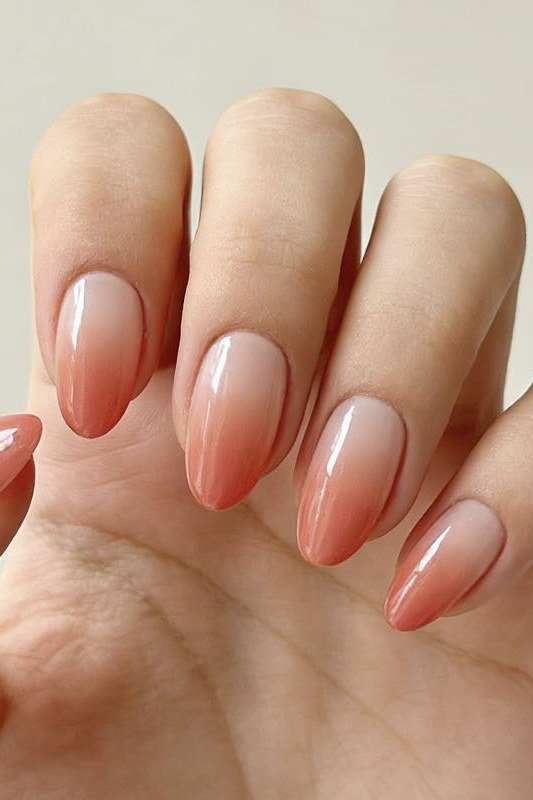 Nude Peach Almond Ombre - Warm nude melts into soft peach on these medium almond nails.