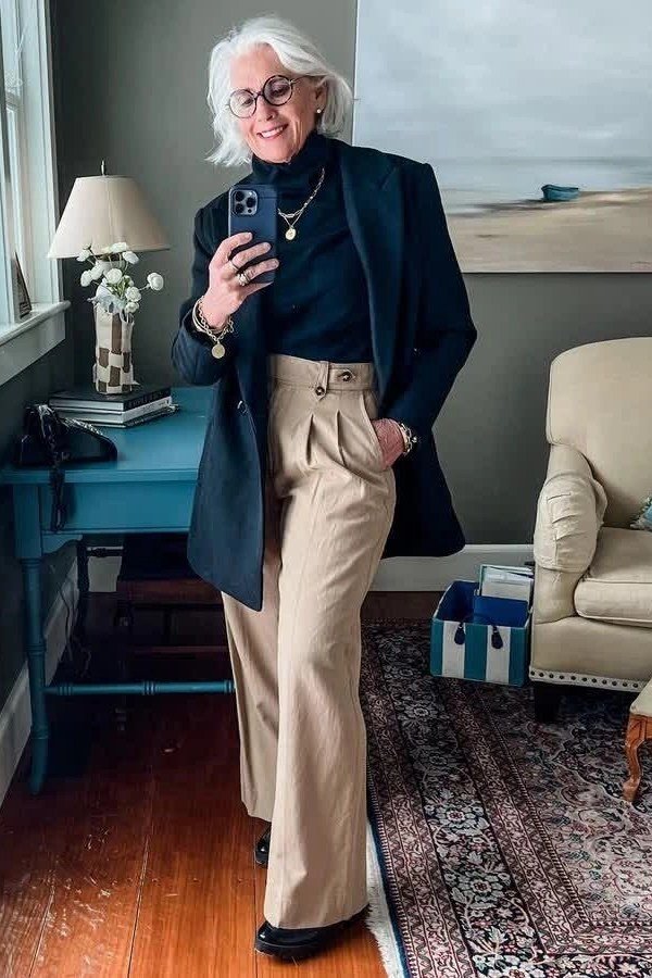 Navy blazer with a cream turtleneck and beige wide-leg trousers for women over 50 at work