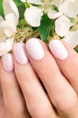 Milky white nails with spring blossom background