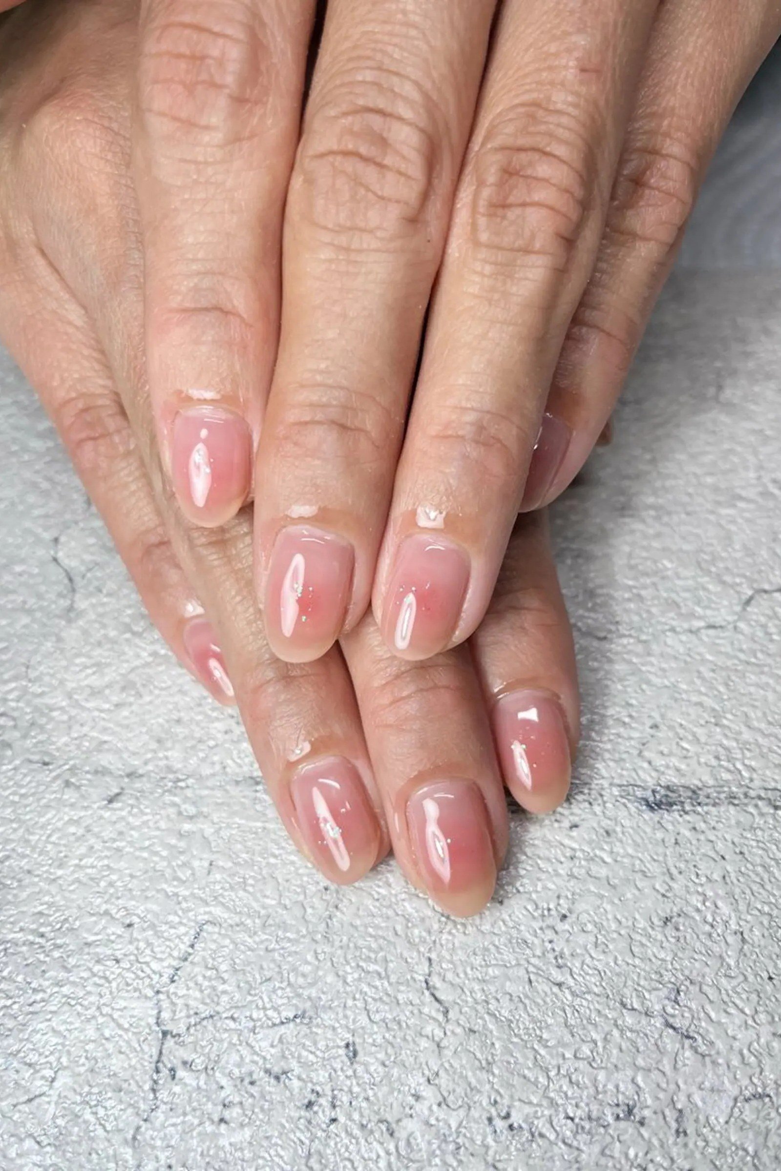 Pink Shimmer Gel Nails - short gel nail idea for women over 50