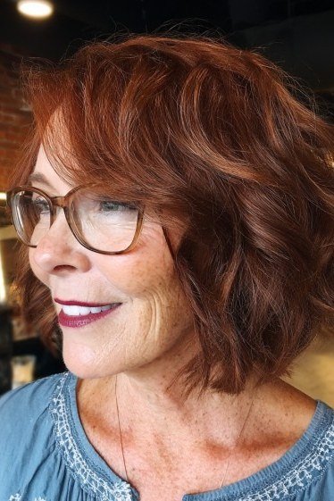 Copper red choppy bob with volume for women over 60, side view