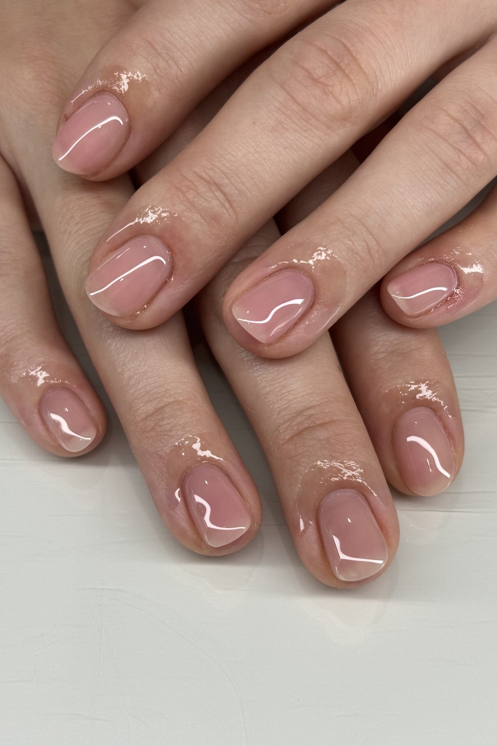Mauve nude nails with overlapping hands