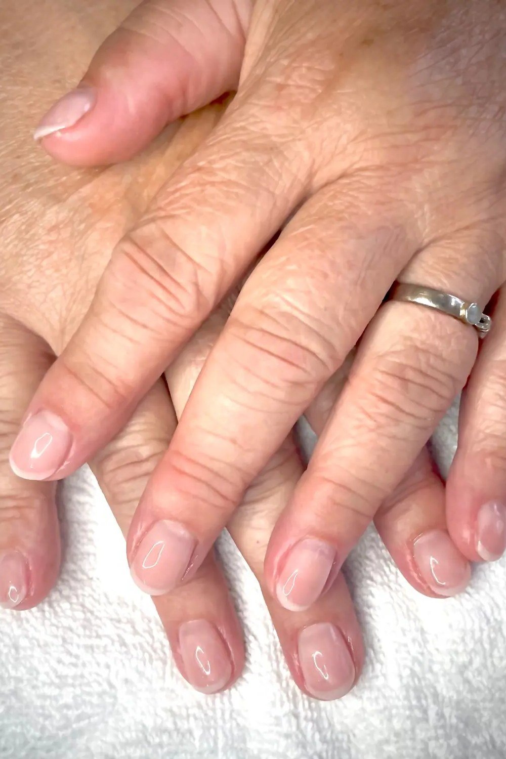 Sheer pink gel nails for mature hands
