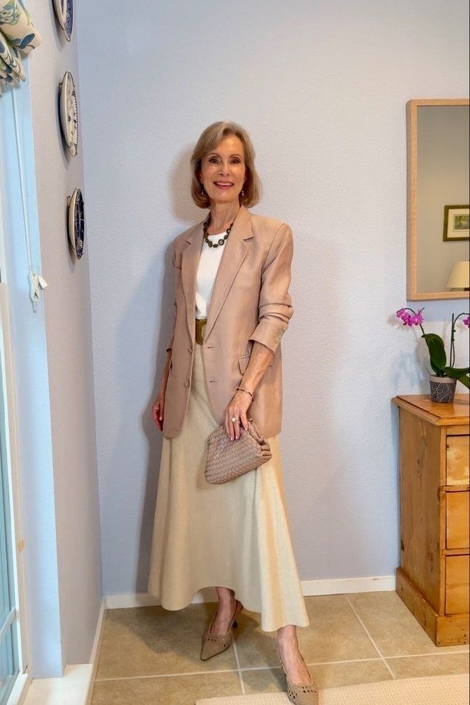 Peach blazer with white top and long cream skirt for women over 60