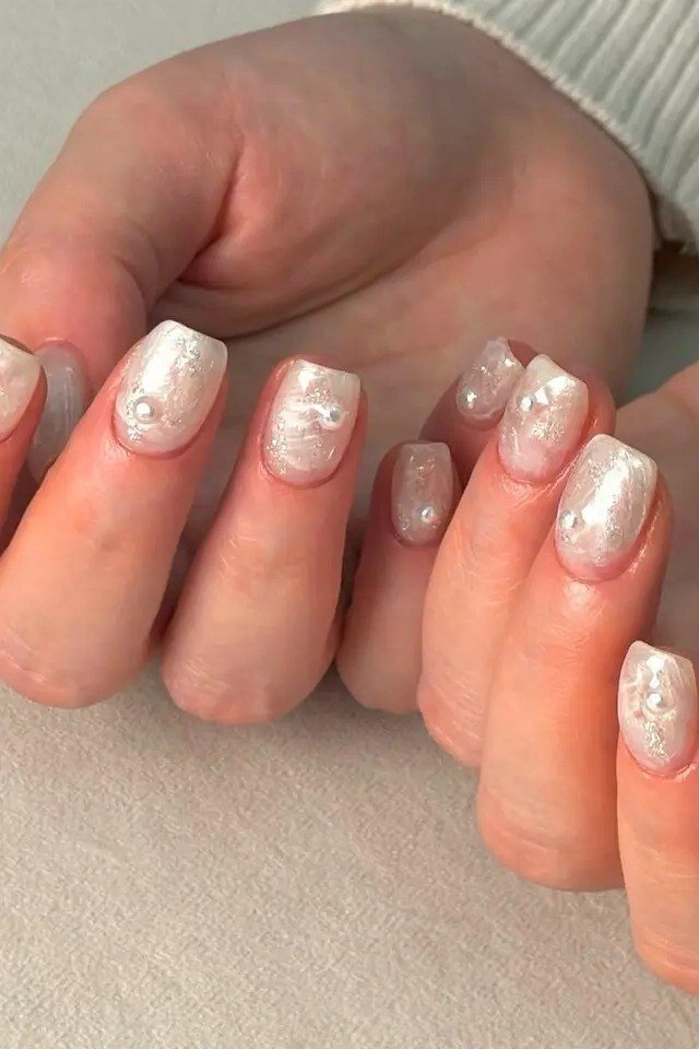 White Pearl Short Nails with Gold Flecks - pearl finish nail idea for women over 60