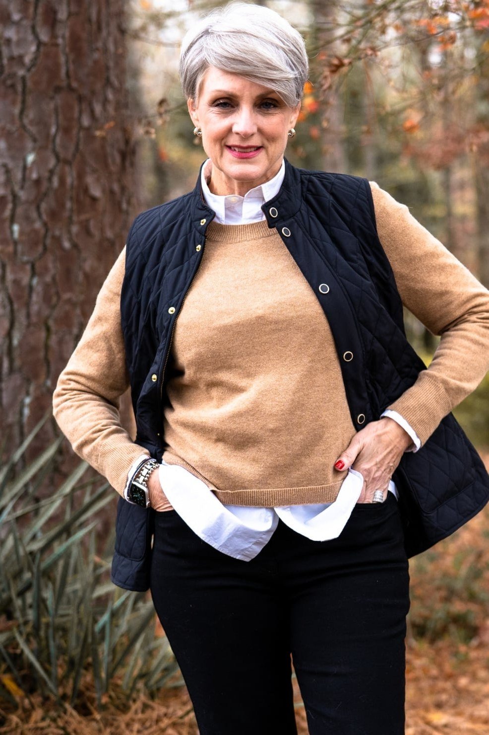 Black quilted vest over tan top outfit for women over 60