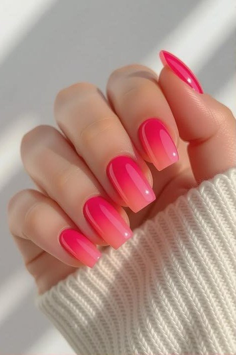 Hot Pink Almond Ombre - Vivid hot pink glows on these medium almond nails, worn with a cozy knit cuff.