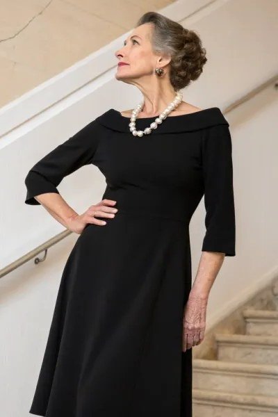 Black three-quarter-sleeve dress with pearl necklace for women over 60