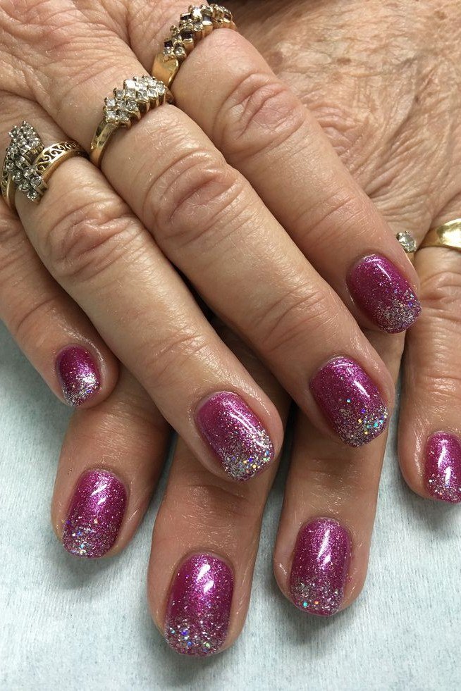 Magenta glitter nail polish with gold rings