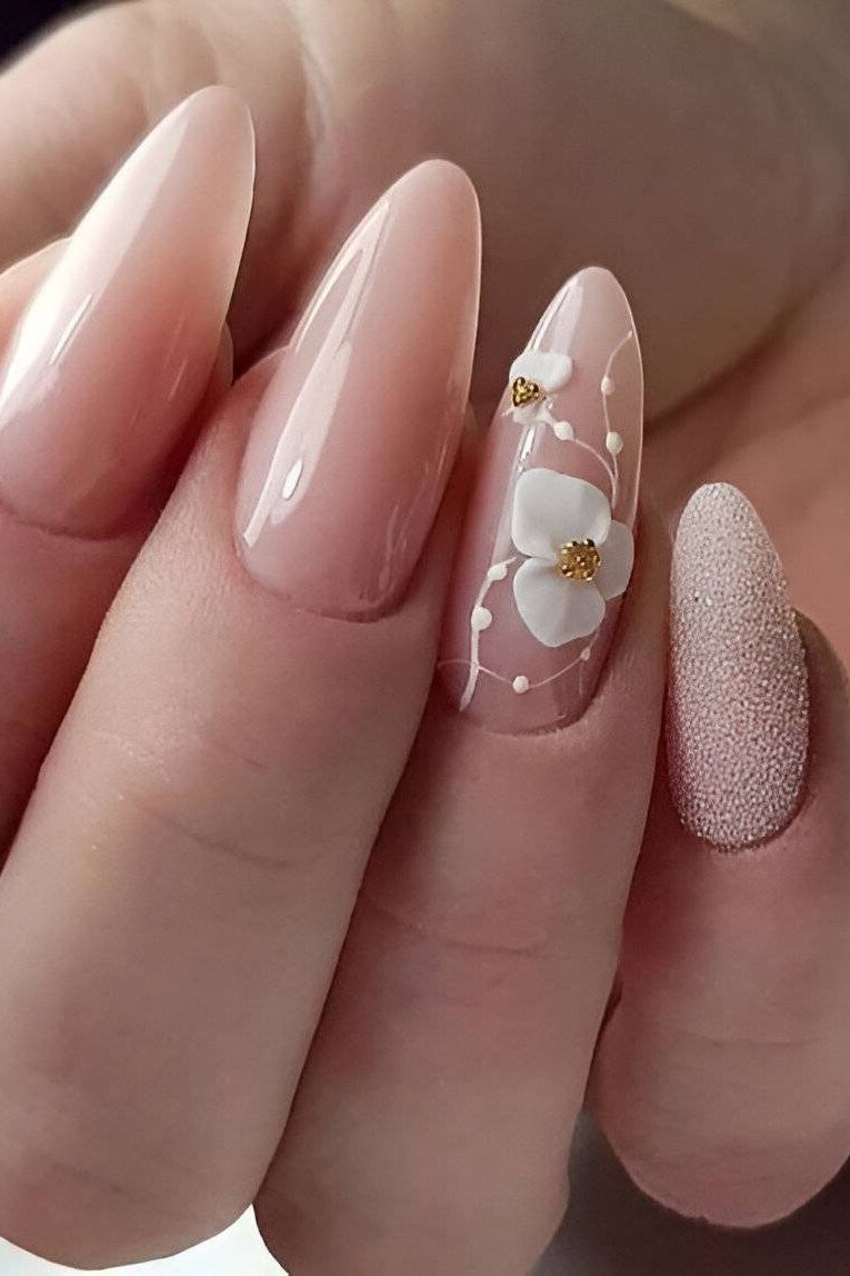 Nude nails with white 3D flower accent for women over 60
