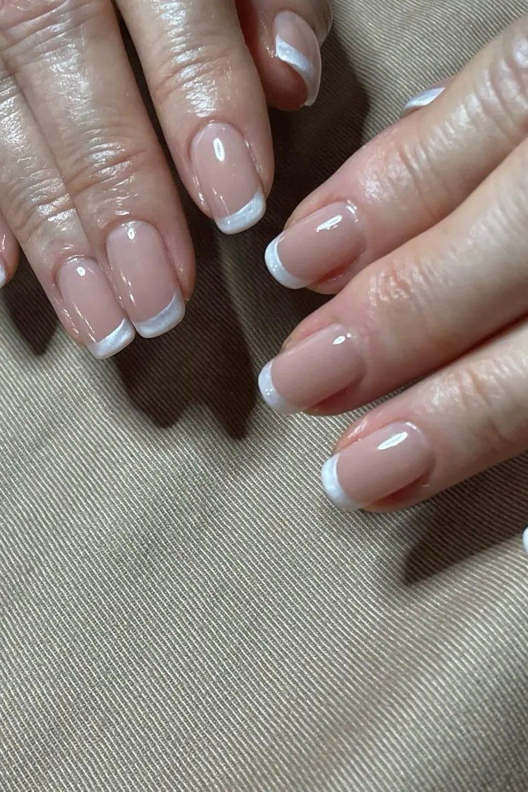 Clean close up of a French manicure
