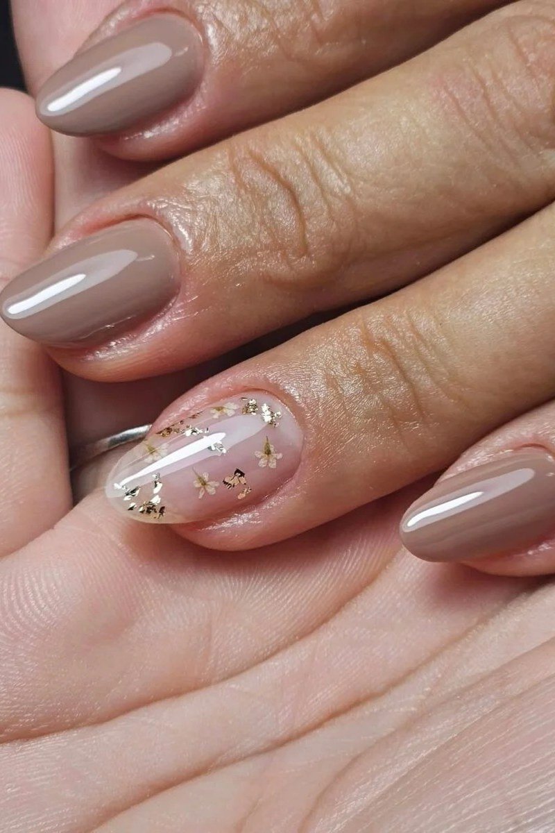 taupe nails with gold glitter accents